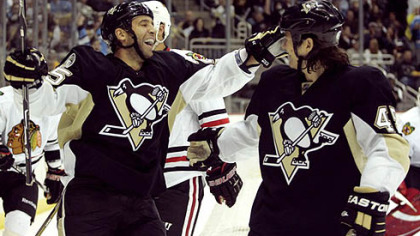 Penguins forward Max Talbot, left, celebrates a goal with teammate Arron Asham.