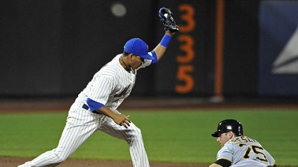 Mets second baseman Ruben Tejada holds up his glove after tagging out the Pirates' Alex Presley on an attempted steal of second in the ninth inning.