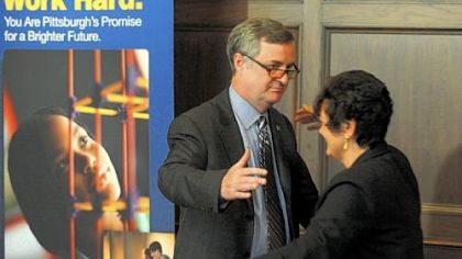 Pittsburgh school board President Theresa Colaizzi walks over to hug Superintendent Mark Roosevelt Wednesday after Mr. Roosevelt announced his resignation.
