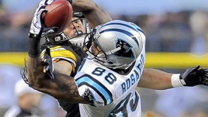 Carolina's Dante Rosario outfights Troy Polamalu for the ball.