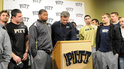 Surrounded by his players, Pitt head coach Dave Wannstedt announces his resignation Tuesday at the team's South Side facility. He will remain in the athletic department in a non-coaching capacity.