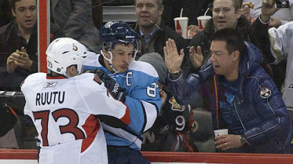 Senators forward Jarkko Ruutu checks Penguins captain Sidney Crosby into the boards during the second period of Sunday's game at Scotiabank Place in Ottawa.