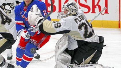 The Rangers' Sean Avery skates past Marc-Andre Fleury as he chases the puck in the second period Monday in New York.