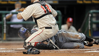 The Mets' Jose Reyes slides safely past Pirates catcher Chris Snyder in the first inning Saturday at PNC Park.