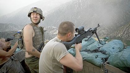 Specialist Misha Pemble-Belkin, left, and fellow soldiers from Battle Company, 173rd US Airborne during a firefight at Outpost Restrepo during combat in Afghanistan's Korengal Valley.