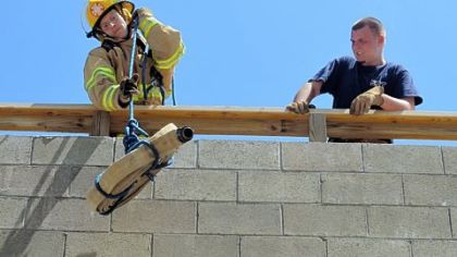 Seth Haskins, 17, a student in the Forbes Road Career and Technology Center emergency response program, lifts a fire hose to the fire tower as Chris Pearce, 18, watches during a practice drill at the school in Monroeville.