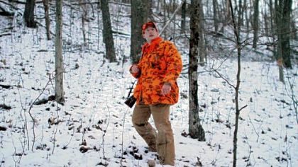 Father Mike Zavage, 28,  walks through Oak Forest, Greene County, on his first hunting trip of the season.