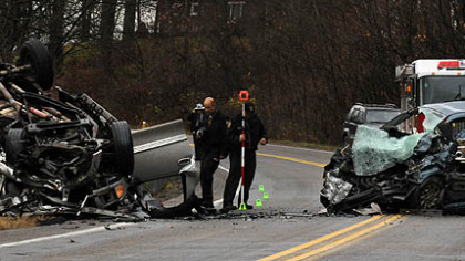 State police investigate the scene of an accident in Butler County in which four people were killed.