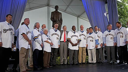 Major League Baseball commissioner Bud Selig, center, is flanked by Rollie Fingers, left, and Hank Aaron as they pose with other players for a picture after a ceremony to unveil the statue of Selig outside Miller Park in Milwaukee on Tuesday. Selig is the former owner of the Milwaukee Brewers.