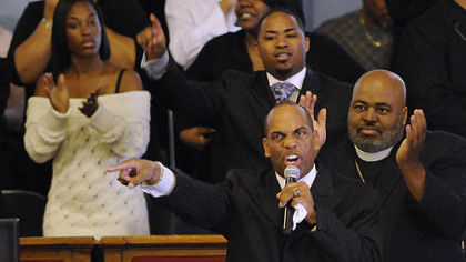 The Rev. Glenn Grayson, center, eulogizes his slain son, Jeron Grayson, who was shot and killed early Sunday  near California University of Pennsylvania.