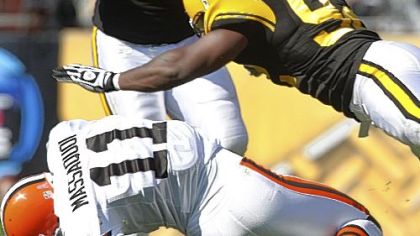 Linebacker James Harrison hits Browns wide receiver Mohamed Massaquoi.