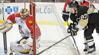 Penguins captain Sidney Crosby wraps the puck around the net as Panthers goaltender Scott Clemmemsen makes the save in the third period of Wednesday's game at Consol Energy Center.