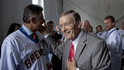 Major League Baseball commissioner Bud Selig talks to former players including Rollie Fingers, left, and Robin Yount, right, before a ceremony to unveil a statue of Selig outside Miller Park on  Tuesday, in Milwaukee. Selig is the former owner of the Milwaukee Brewers.