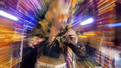 Dan Casne, the "Blonde Elvis of Pittsburgh," performs at his Casne World, an old VFW hall in Mount Oliver, below.