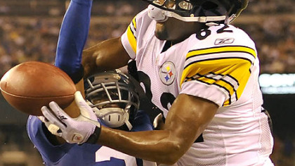 New York's Bruce Johnson breaks up a pass into the end zone for Antwaan Randle El in the first half Saturday night at New Meadowlands Stadium in East Rutherford, N.J.