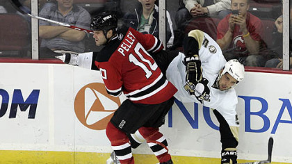 Devils forward Rod Pelley flips Penguins defenseman Deryk Engelland during the third period.