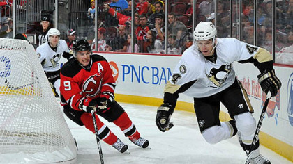 Devils forward Zach Parise challenges defenseman Zbynek Michalek for possession of the puck during the second period.