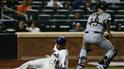 The Mets' Ike Davis slides safely into home after the Pirates' Chris Snyder fails to catch third baseman Pedro Alvarez's throw in the fourth inning Wednesday at Citi Field.