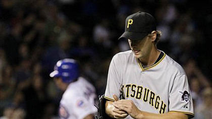 Pirates relief pitcher Brian Burres returns to the mound after giving up a two-run homerun to Chicago Cubs' Carlos Zambrano, background, that also scored  Koyie Hill, during the fifth inning of last night's game at Wrigley Field in Chicago.