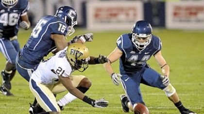 Connecticut's Robbie Frey recovers a Pitt fumble in front of Buddy Jackson in the second half of Thursday in East Hartford, Conn. The recovery set up a Connecticut touchdown.