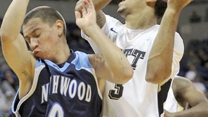 Cameron Wright, a freshman guard from Benedictine High School in Cleveland, drives to the basket against Northwood's Tracy Parks in Pitt's opening exhibition game Sunday at the Petersen Events Center.