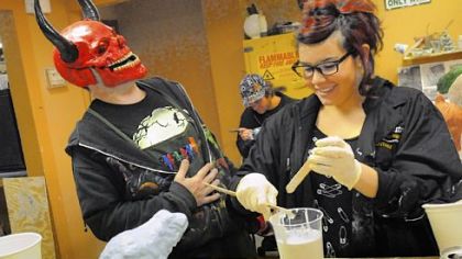Wearing a red devil mask, instructor Shawn Ronzio of Tom Savini's Special Make-up Effects Program shares a laugh with Alana Schiro, 19, of New York at a sculpture class. The Savini program is part of the Douglas Education Center in Monessen.