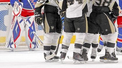 The Penguins celebrate a goal by Kris Letang as Rangers goalie Henrik Lundqvist looks on in the second period Monday.