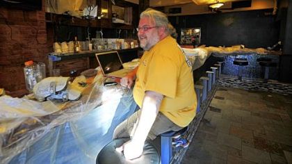 Rodney Swartz, one of five partners who renovated the Shiloh Inn, sits in the bar area of the restaurant.