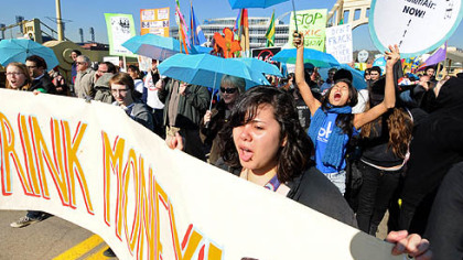A coalition of groups protesting Marcellus Shale gas drilling made their way across the Rachel Carson Bridge on their way to the David L. Lawrence Convention Center to protest the gas drilling drilling conference being held there. The blue umbrellas symbolize clean water.