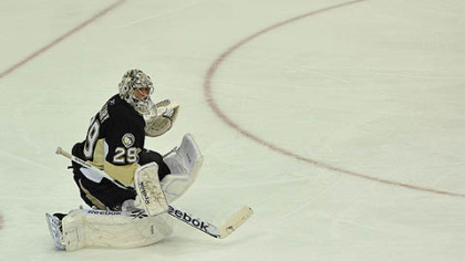 Penguins goaltender Marc-Andre Fleury stops a puck during the first period.