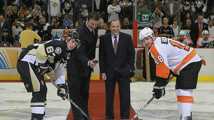Penguins owner Mario Lemieux drops the puck between Penguins captain Sidney Crosby and Flyers captain Mike Richards as NHL commissioner Gary Bettman looks during a ceremonial faceoff.