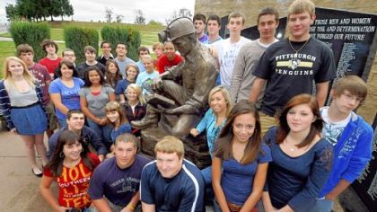 Ray VanSickle's Spanish 3 and 4 classes at Bethlehem-Center High School have written letters in Spanish to families of the miners trapped deep in a mine in Chile. Ian Sowers' (front, middle) father, Brad, is a coal miner. They are gathered around a coal miner statue outside the school.