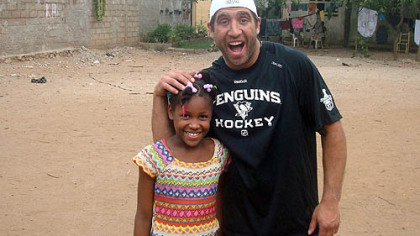 The Penguins' Max Talbot shares a laugh with one of the children at the orphanage.
