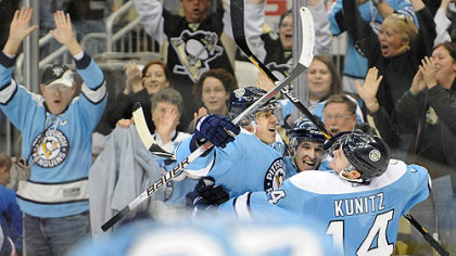 Penguins defenseman Alex Goligoski, center, celebrates his winning overtime goal with Evgeni Malkin, left, and Chris Kunitz.