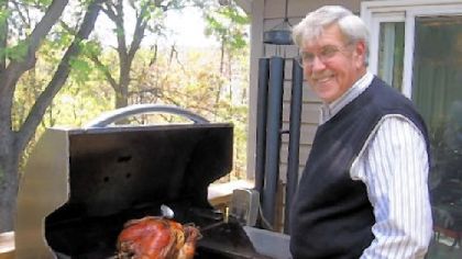 Howard "Bucky" Noll grills a turkey for an October Thanksgiving at his Brighton Township home.