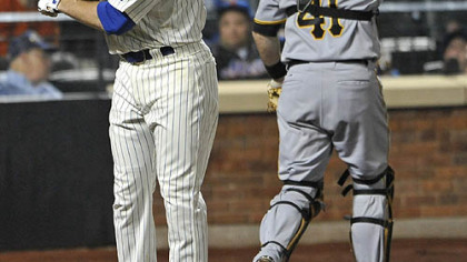 The Mets' Ike Davis throws his bat behind Pirates catcher Ryan Doumit after striking out against Pirates pitcher Chris Resop for the third out in the ninth inning.