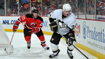 Penguins forward Matt Cooke challenged for possession of the puck by Devils defenseman Matt Taormina during the third period.