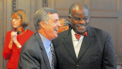 Pittsburgh Public Schools Superintendent Mark Roosevelt, left, shares a laugh with school board  member Mark Bentley Sr., after announcing his resignation.