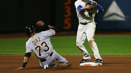 Mets second baseman Ruben Tejada completes a double play while the Pirates' Argenis Diaz unsuccessfully slides into second base in the eighth inning.
