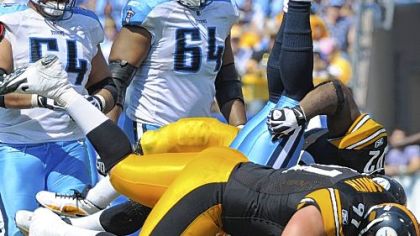 Steelers Aaron Smith stands Titans quarterback Vince Young on his head in a game earlier this season.