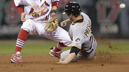 Alex Presley, pinch-running for the Pirates, steals second as St. Louis shortstop Brendan Ryan cannot handle the throw from catcher Matt Pagnozzi in the seventh inning.
