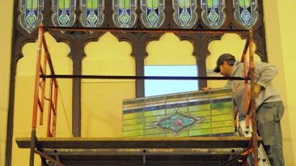 Bryant Raymond of Sarver installs a stained-glass window Tuesday at the Union Project in Highland Park. Since 2004, the Union Project has been restoring and reinstalling 153 neo-gothic style stained-glass windows throughout the former church building.