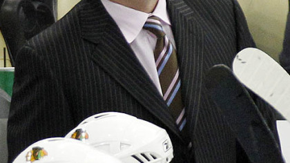 Blackhawks coach Joel Quenneville stands behind the bench during the second period.