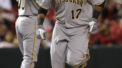 The Pirates' Pedro Alvarez is congratulated by third base coach Tony Beasley after his solo home run in the second inning Monday at Busch Stadium.
