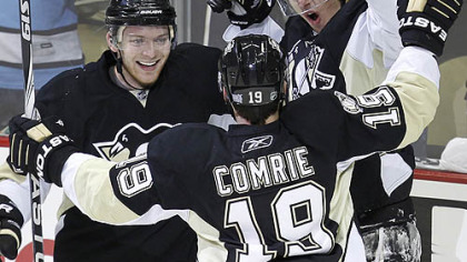 Penguins forward Evgeni Malkin, right, celebrates his first-period goal with teammates Mark Letestu and Mike Comrie.