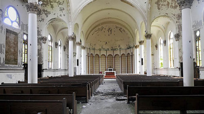 The ceiling and plaster walls have peeling paint at the former Our Lady of Help Christians church in Larimer.