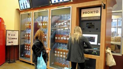 Mallory Mullady, left and friend Laura Burnes, students at the University of Pittsburgh, buy wine from the kiosk at the Giant Eagle Market District in Shadyside.