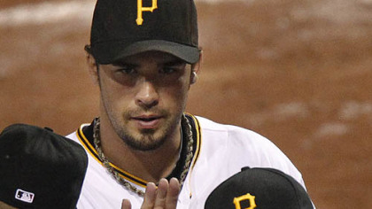The Pirates' Garrett Jones, top, and Pedro Alvarez celebrate with teammates.