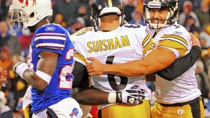 Kicker Shaun Suisham is mobbed by teammates including Daniel Sepulveda, right, after kicking the winning field goal against the Bills in overtime Sunday at Ralph Wilson Stadium in Orchard Park, N.Y.