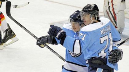Sidney Crosby gets congratulations from teammate Evgeni Malkin after Crosby scored his 200th career goal and second of three goals in Saturday's game against Calgary.